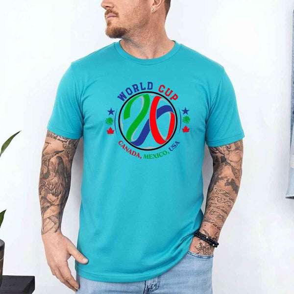 May include a person wearing a Turquoise colored 2026 World Cup T-shirt featuring bold soccer graphic and relaxed fit.