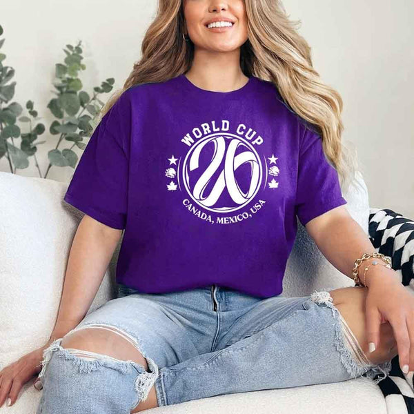 May include a person wearing a Purple colored 2026 World Cup T-shirt featuring bold soccer graphic and relaxed fit.