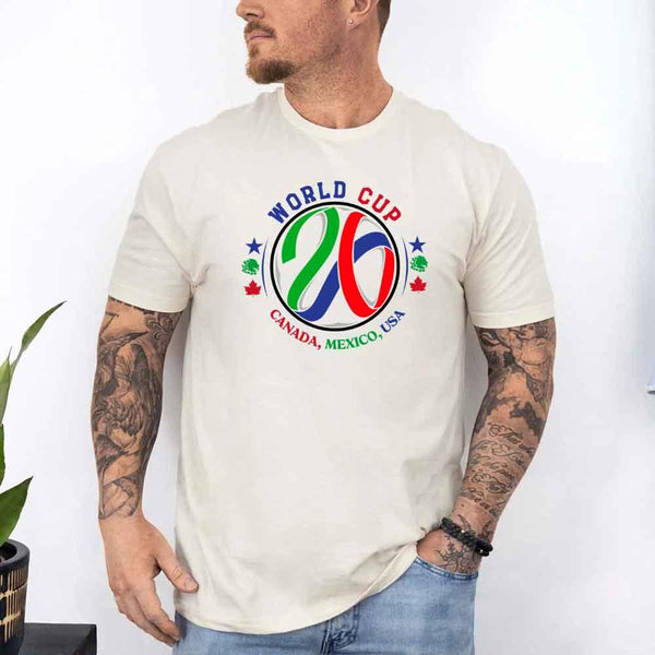 May include a person wearing a Soft Cream colored 2026 World Cup T-shirt featuring bold soccer graphic and relaxed fit.