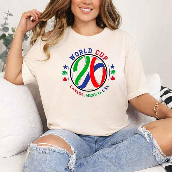 May include a person wearing a Soft Cream colored 2026 World Cup T-shirt featuring bold soccer graphic and relaxed fit.