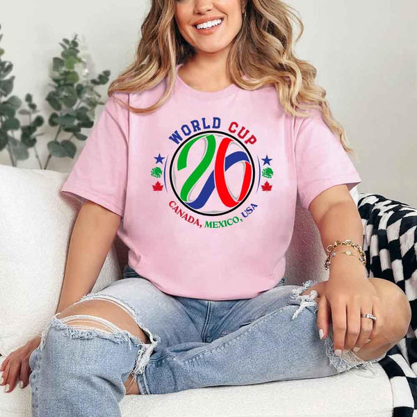 May include a person wearing a Pink colored 2026 World Cup T-shirt featuring bold soccer graphic and relaxed fit.