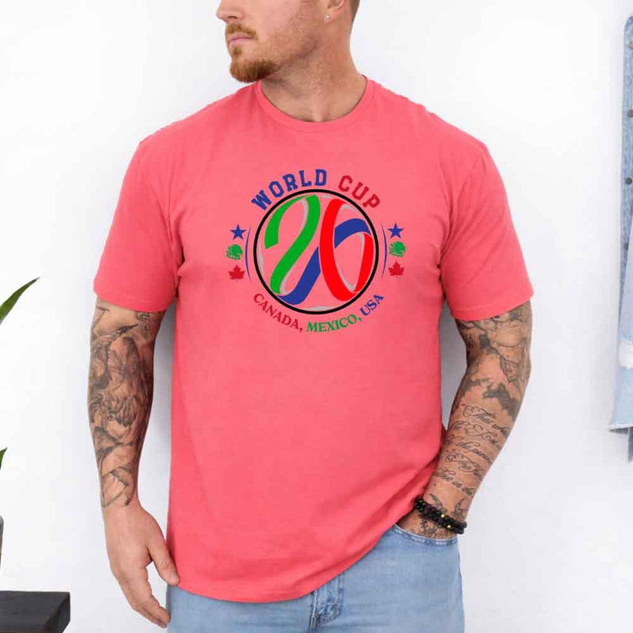 May include a person wearing a Coral Silk colored 2026 World Cup T-shirt featuring bold soccer graphic and relaxed fit.