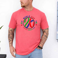 May include a person wearing a Coral Silk colored 2026 World Cup T-shirt featuring bold soccer graphic and relaxed fit.