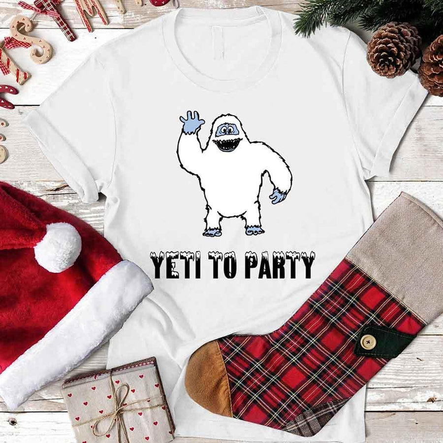 May include a Christmas graphic tee featuring a friendly yeti and festive text displayed on a flat surface.