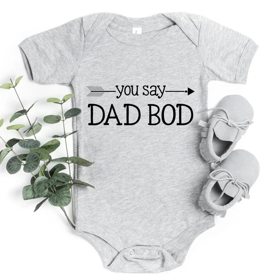 May include a person wearing a funny dad graphic t-shirt with the phrase “You Say Dad Bod, I Say Father Figure”.